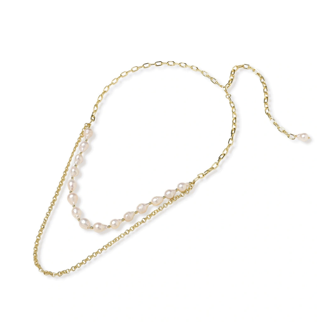 Flat lay of the baroque pearl and gold chain necklace