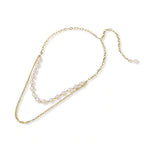 Flat lay of the baroque pearl and gold chain necklace