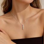 Close-up of the stainless steel bar necklace worn at the collarbone