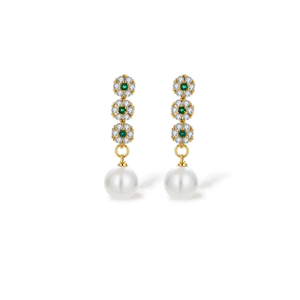 Close-up of the green cubic zirconia and pearl drop earrings