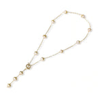 Flat lay showing the Y-drop shape of the baroque pearl station lariat