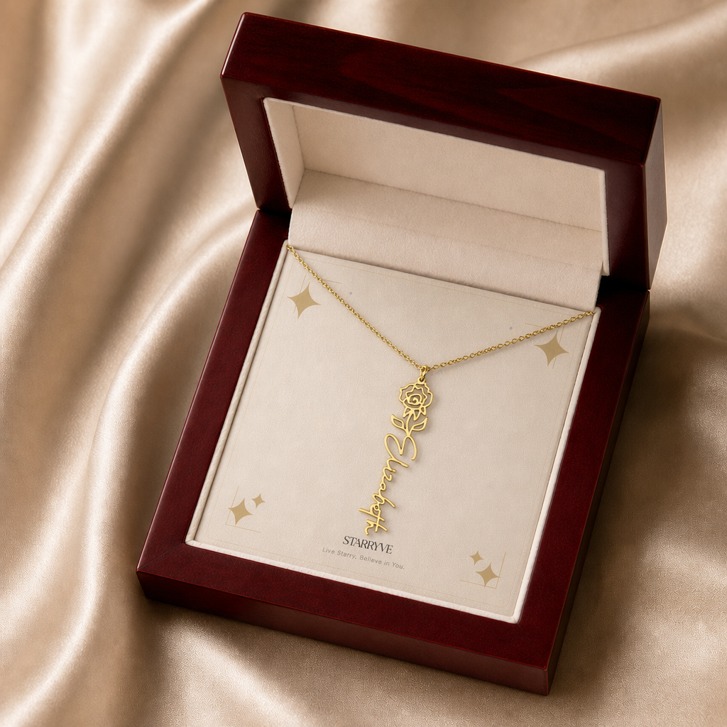 Gold flower name necklace with the June rose birth flower, shown in a mahogany LED luxury gift box