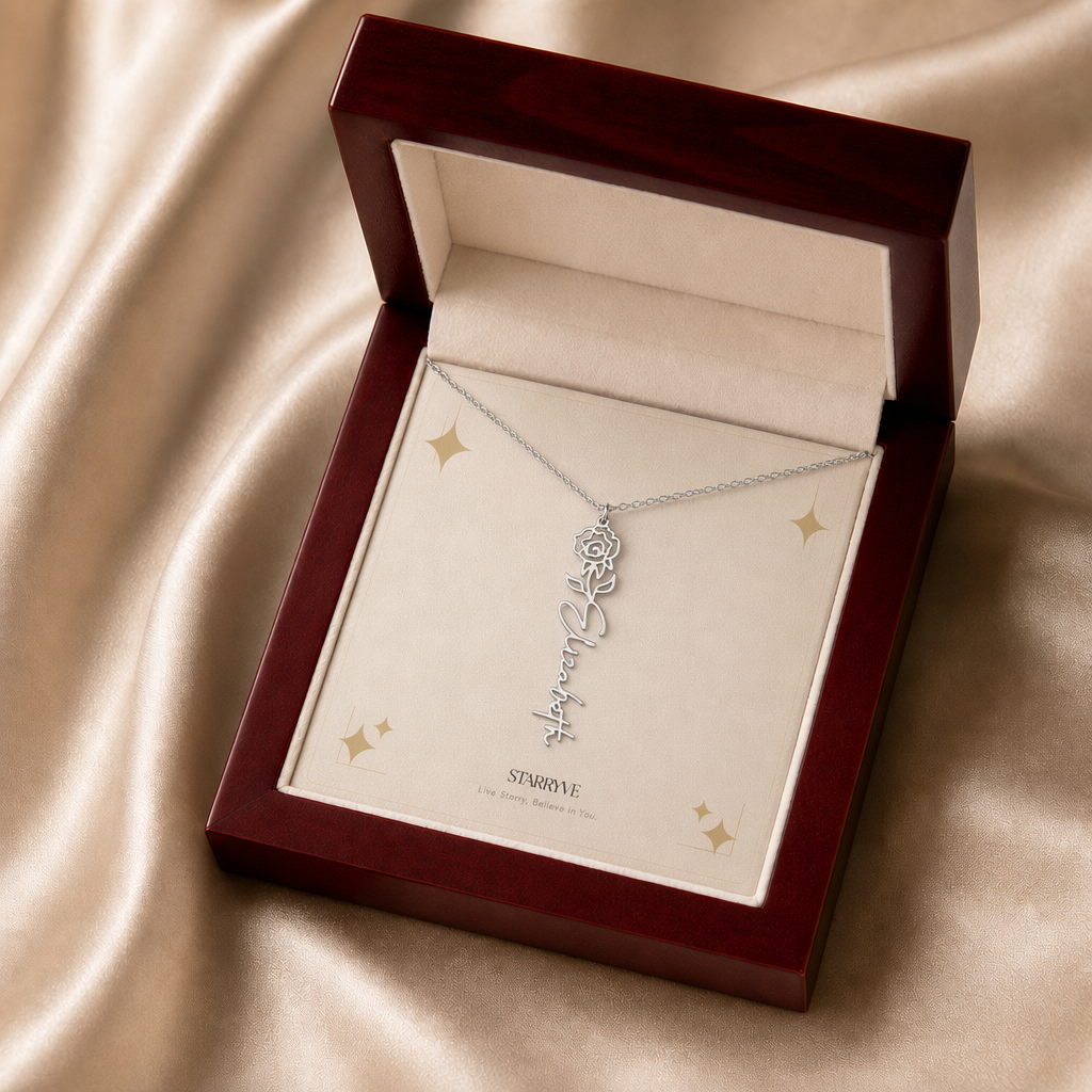 Silver flower name necklace with the June rose birth flower, shown in a mahogany LED luxury gift box