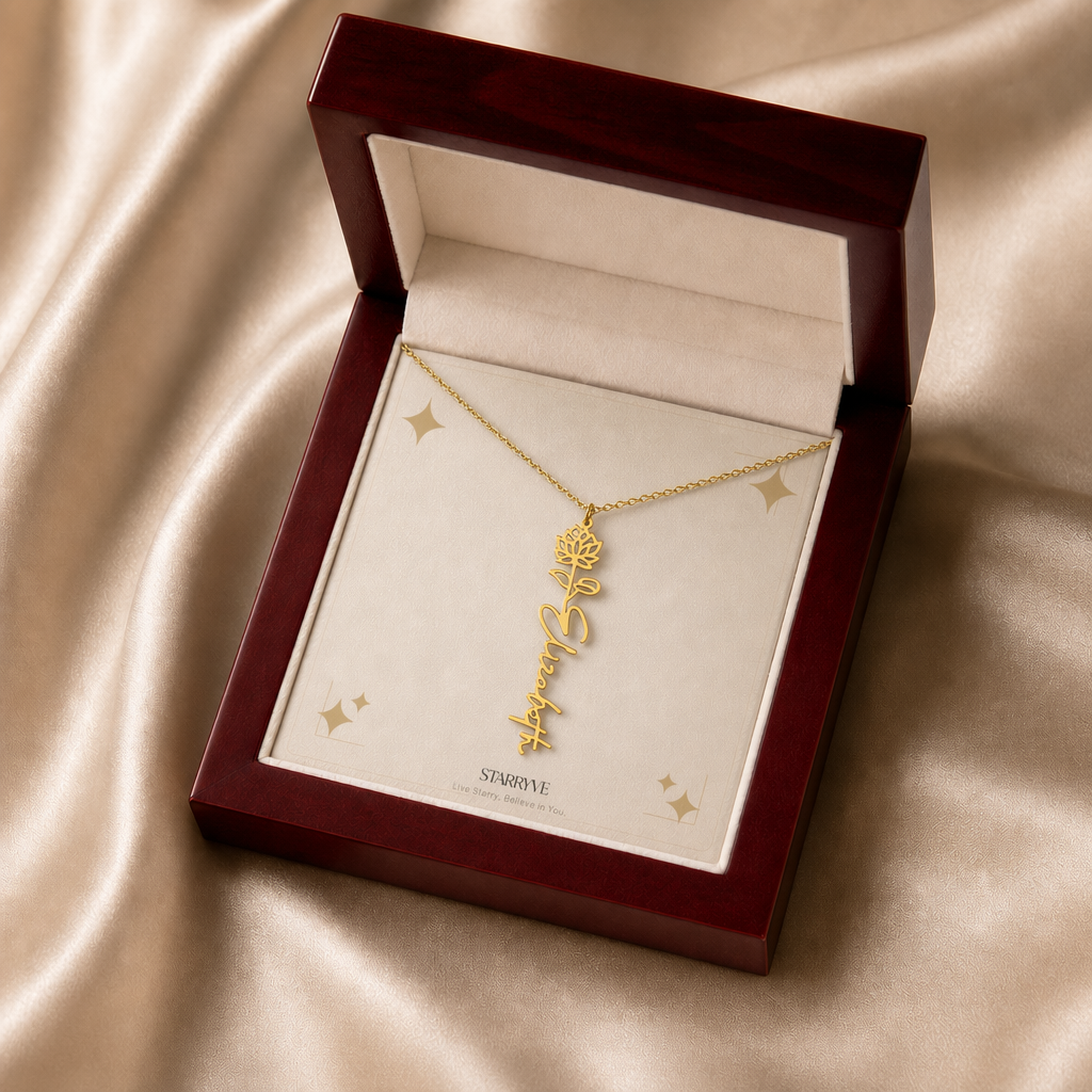 Gold flower name necklace with the July water lily birth flower, shown in a mahogany LED luxury gift box
