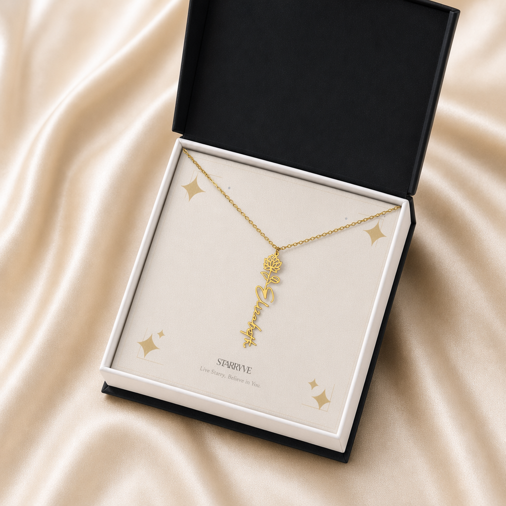 Gold flower name necklace with the July water lily birth flower, shown in a black standard gift box