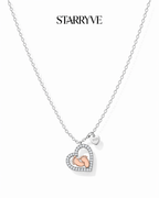 Sterling silver heart necklace with rose gold baby feet and a cubic zirconia border