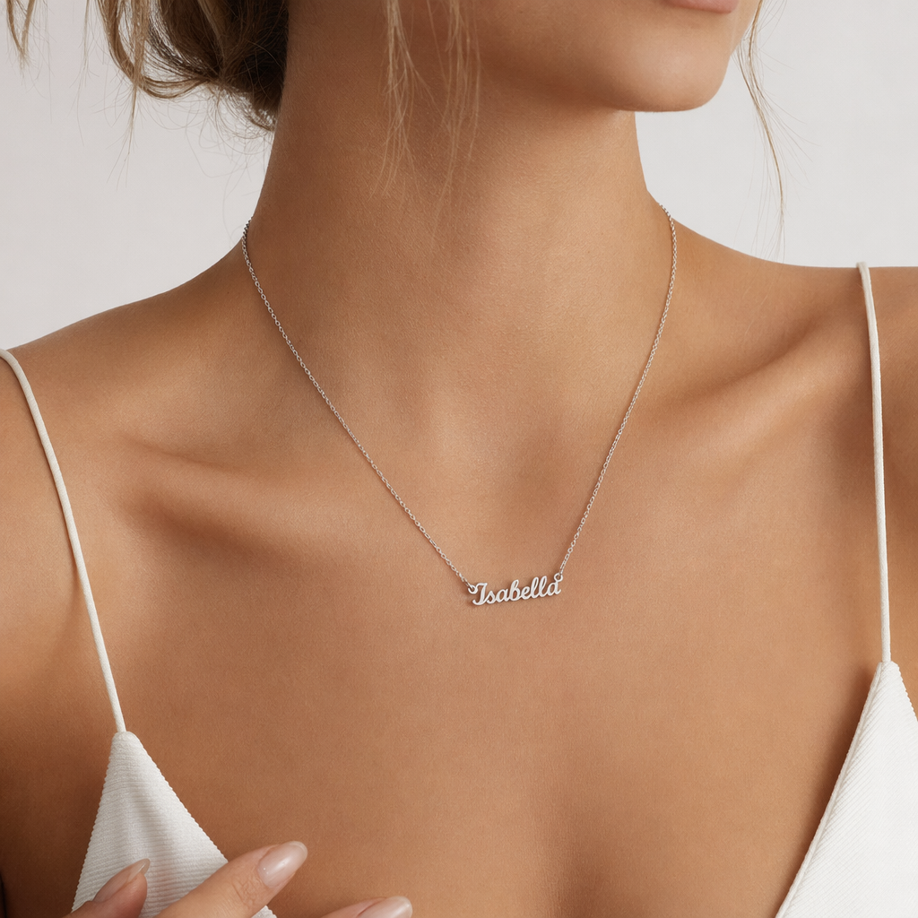 Close-up of the silver custom name necklace at the neckline