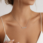 Close-up of the silver custom name necklace at the neckline