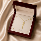 Gold flower name necklace with the August poppy birth flower, shown in a mahogany LED luxury gift box