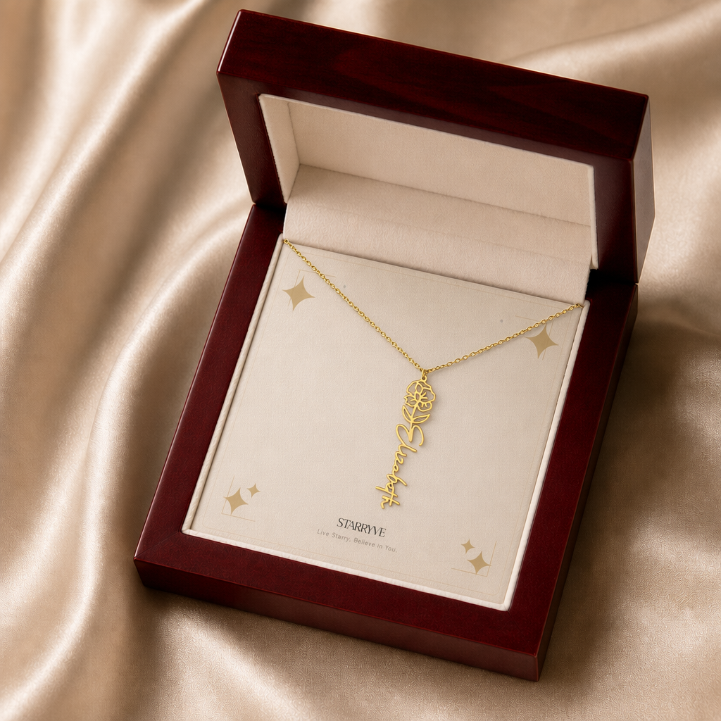 Gold flower name necklace with the August poppy birth flower, shown in a mahogany LED luxury gift box