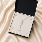 Silver flower name necklace with the August poppy birth flower, shown in a black standard gift box