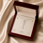 Silver flower name necklace with the September morning glory birth flower, shown in a mahogany LED luxury gift box