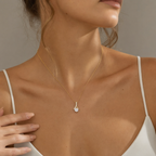 Close-up of the yellow gold cubic zirconia ribbon necklace at the neckline