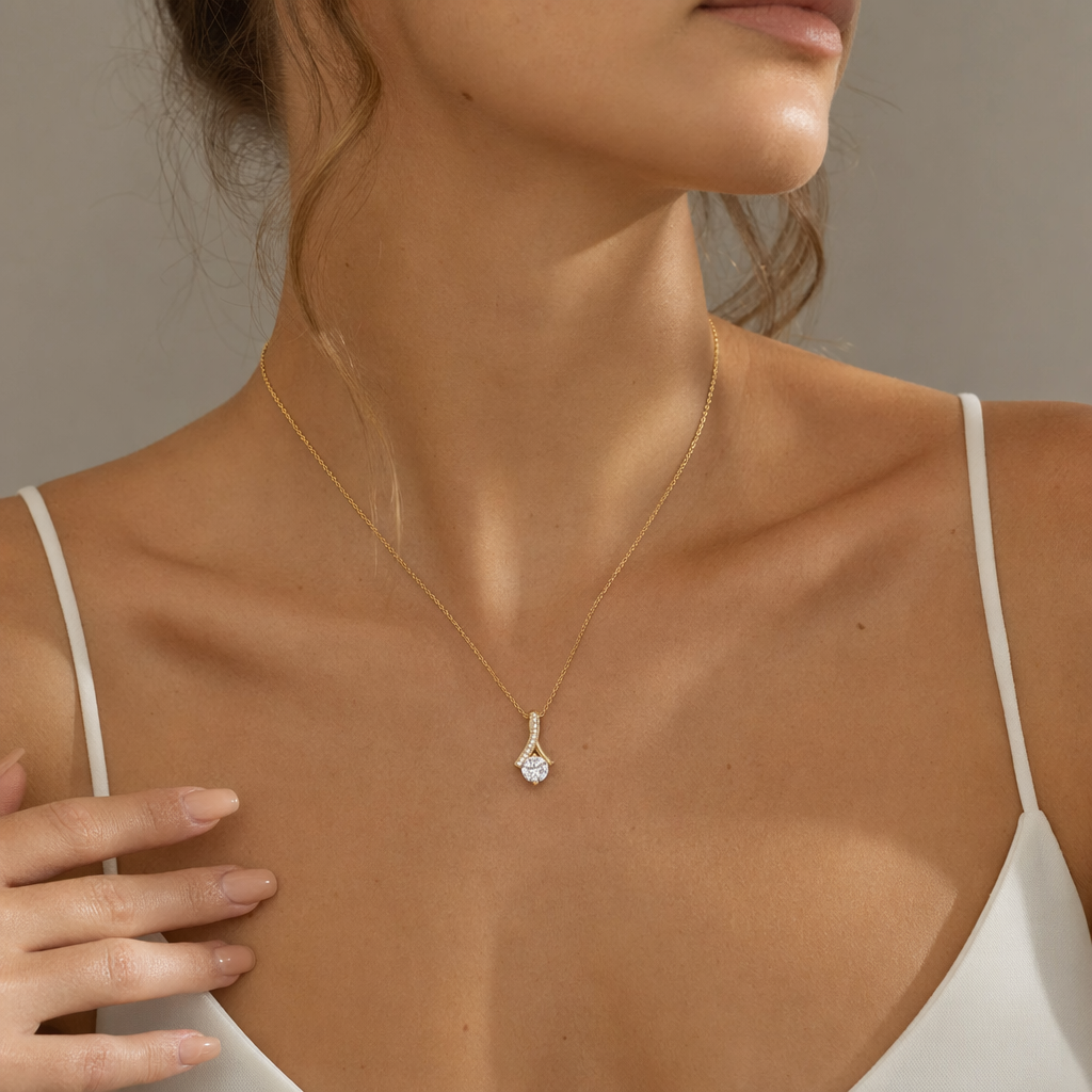 Close-up of the yellow gold cubic zirconia ribbon necklace at the neckline