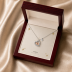 Baby feet heart necklace displayed in a mahogany LED luxury gift box