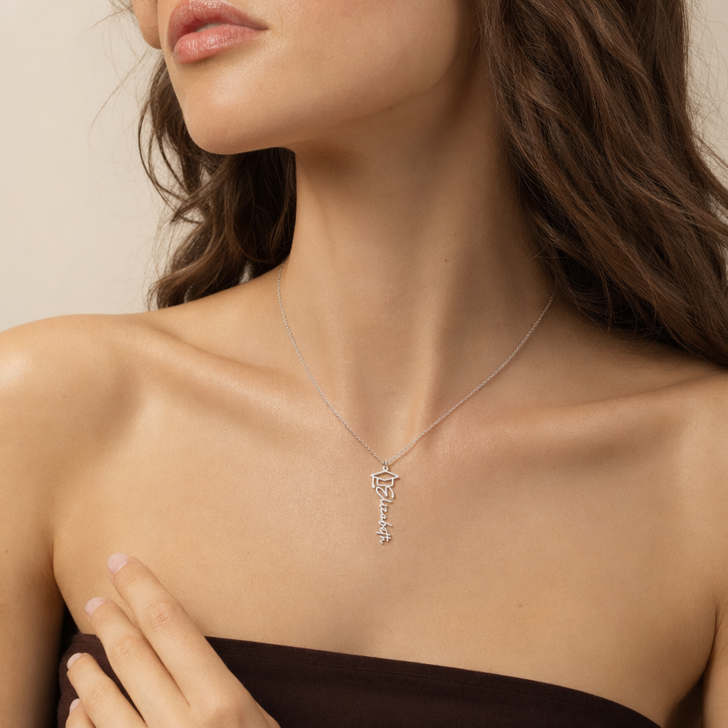 Woman wearing the silver graduation cap name necklace with a dark top