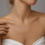 Close-up of the white gold cubic zirconia ribbon necklace at the neckline