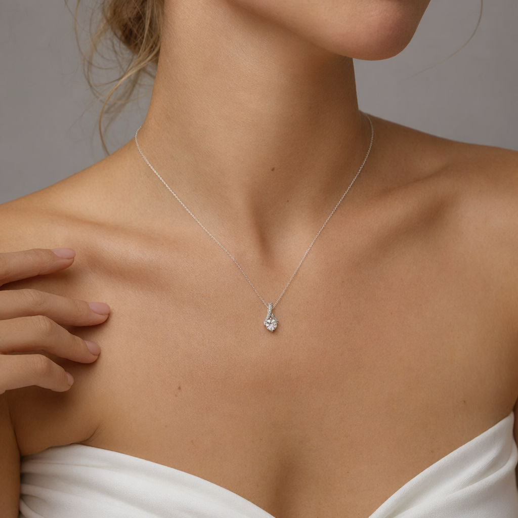Close-up of the white gold cubic zirconia ribbon necklace at the neckline