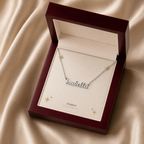 Silver custom name necklace displayed in a mahogany LED luxury gift box