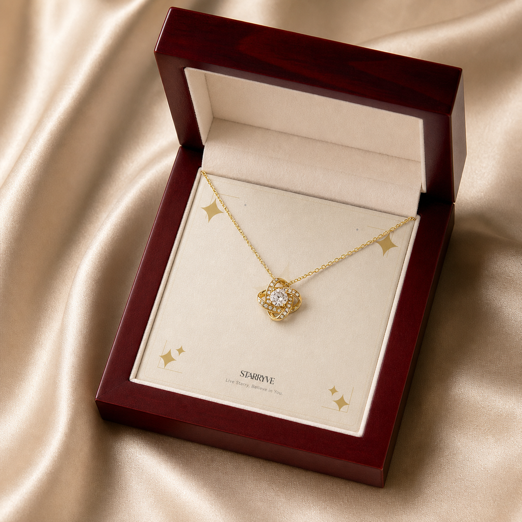 Yellow gold love knot necklace displayed in a mahogany LED luxury gift box