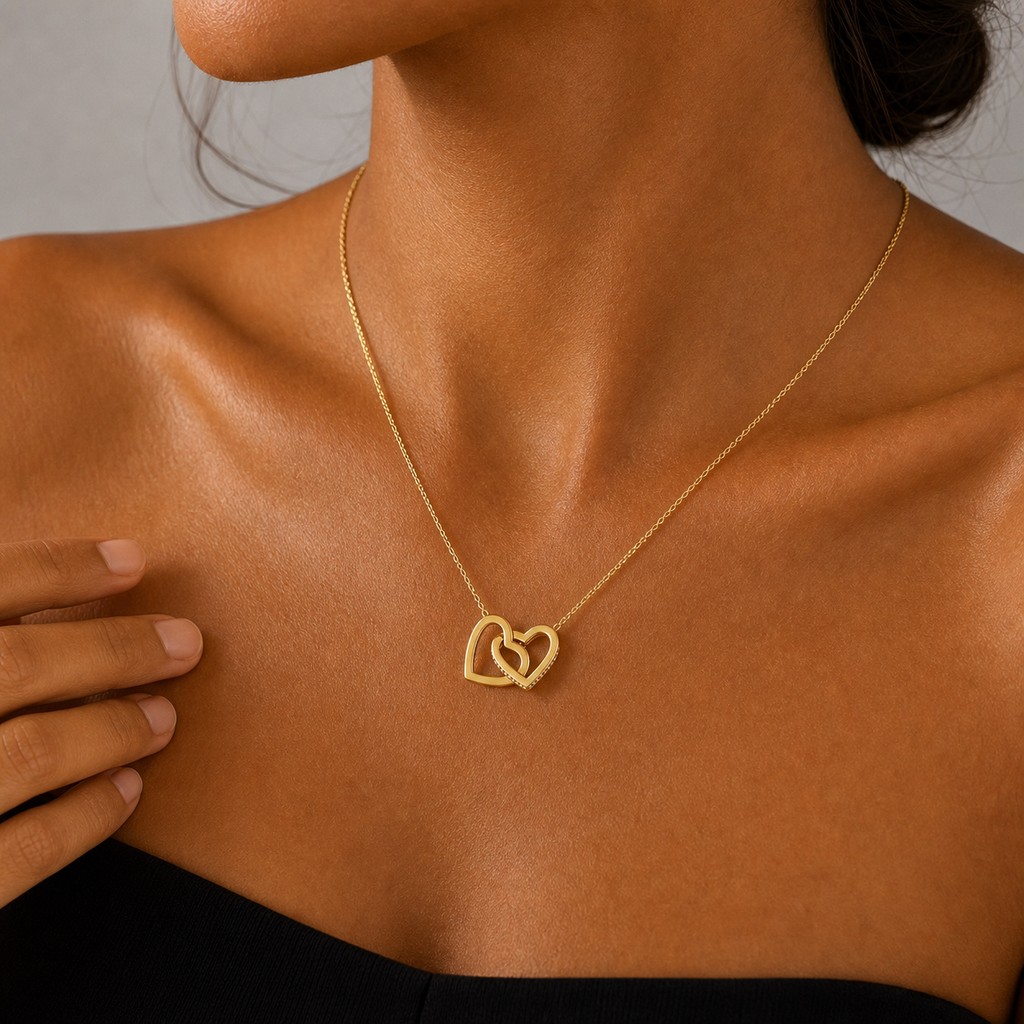 Woman wearing the gold interlocking hearts necklace