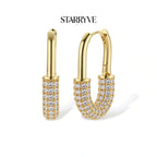 Golden Glow Huggie Hoops with STARRYVE logo
