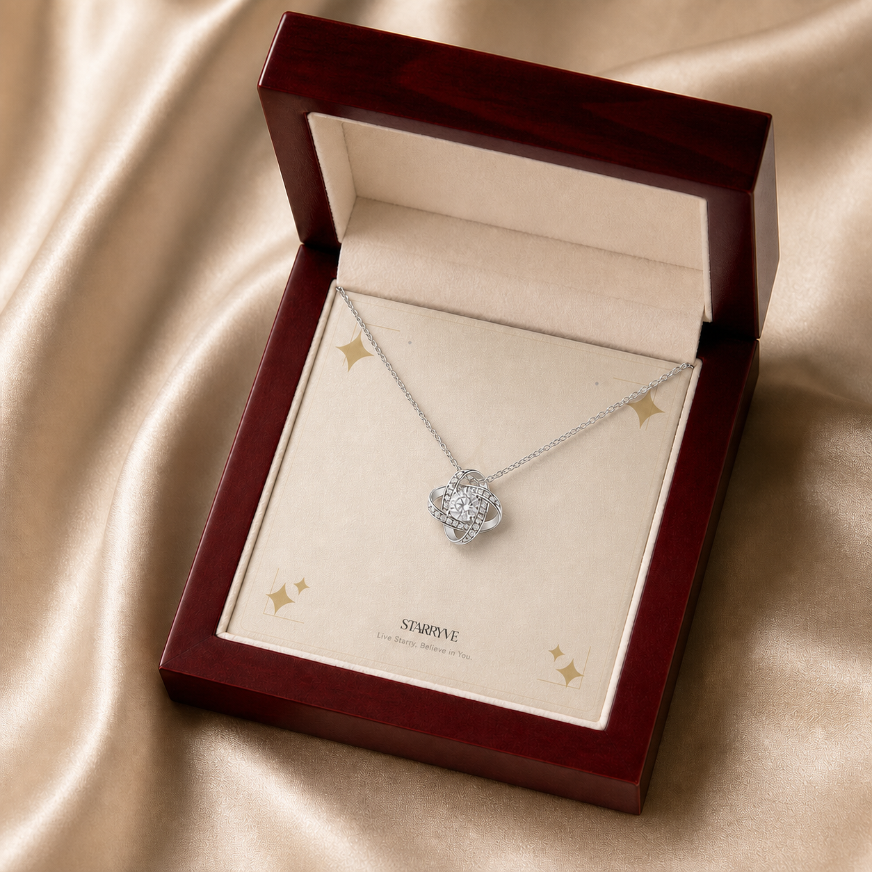 White gold love knot necklace displayed in a mahogany LED luxury gift box
