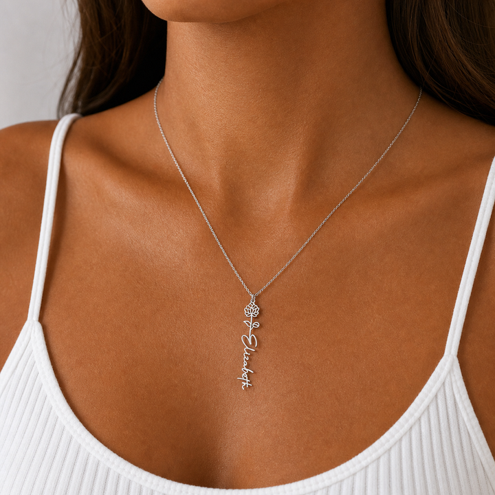 Woman wearing the silver flower name necklace with a white top